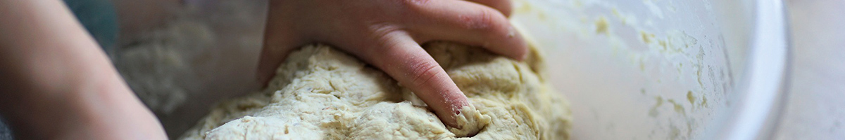 Chapter banner: Hands kneading dough