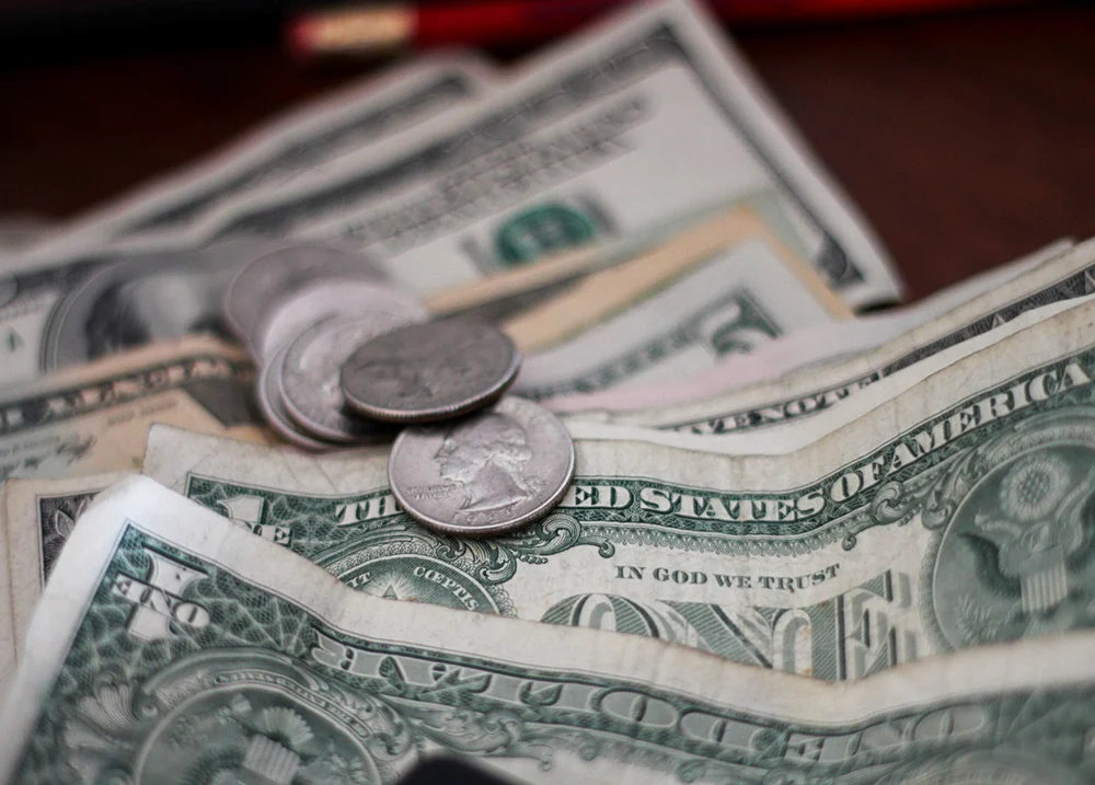 Crinkled bills with some coins