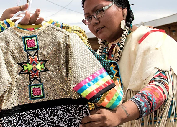 Woman looking at shirts with colorful tribal prints