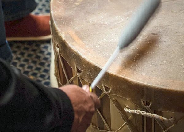 Person beating large drum