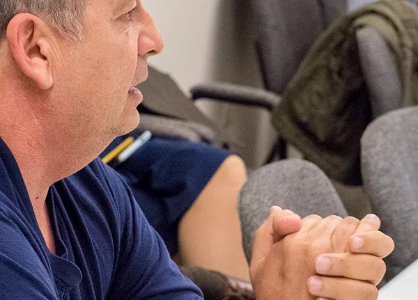 Man sitting with clasped hands