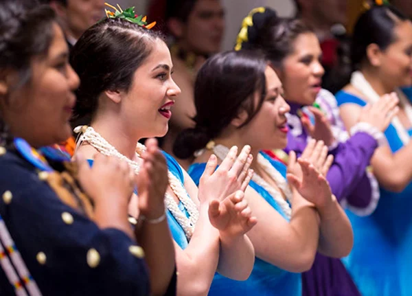 Women in traditional attire perform dance
