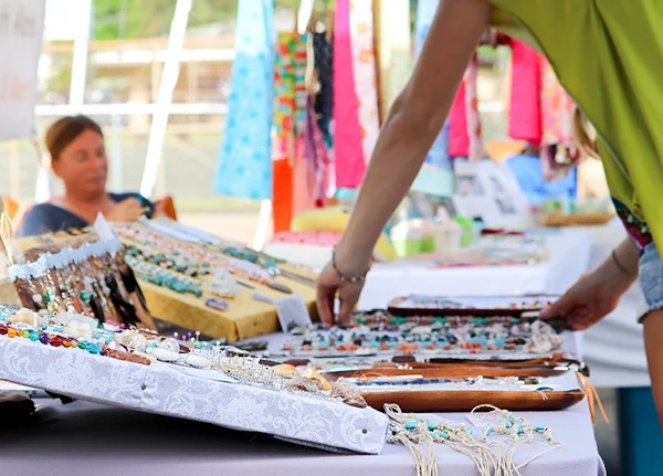 Person shopping at craft fair booth