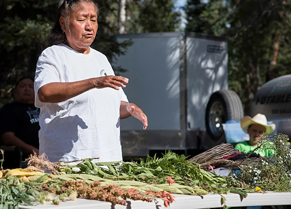 Woman selling flowers and crops