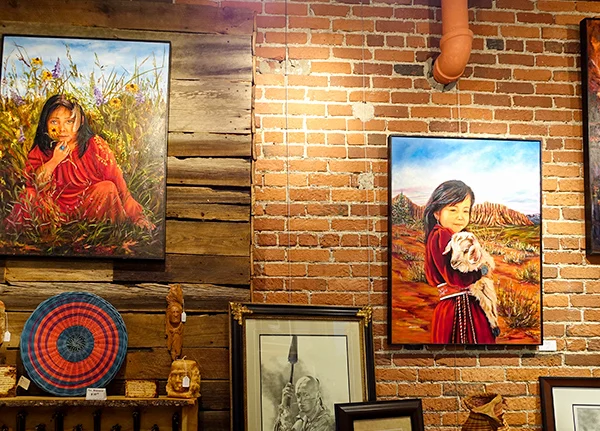 Native American artwork hung on a brick wall