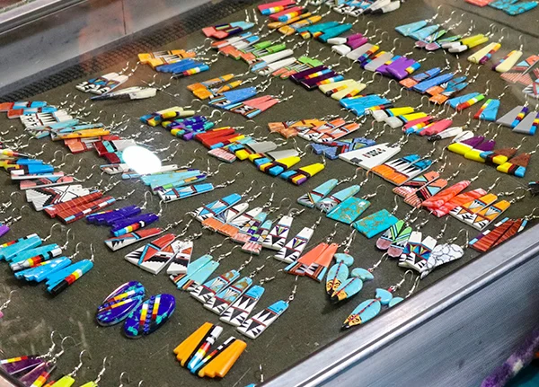 Earrings with tribal patterns for sale in a display case