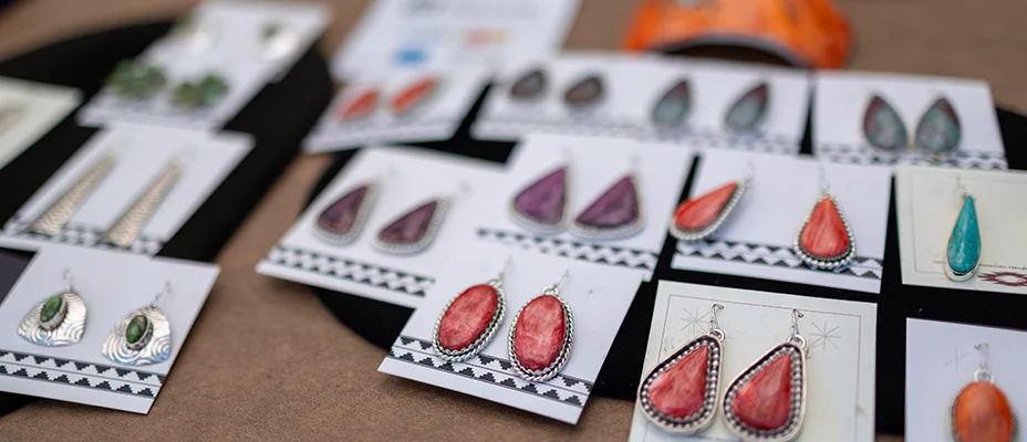 Stone earrings in holders laid out on a tabletop