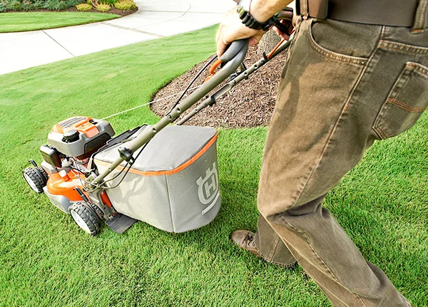 Person pushing lawn mower