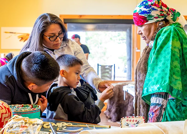 A mom with two kids shopping at a craft booth