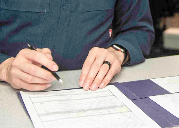 Person filling out paperwork