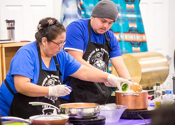Two people cooking together