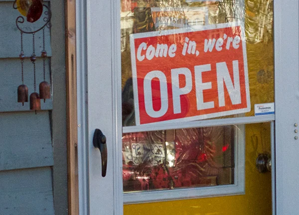 Door with a Come in, We're Open sign in the window
