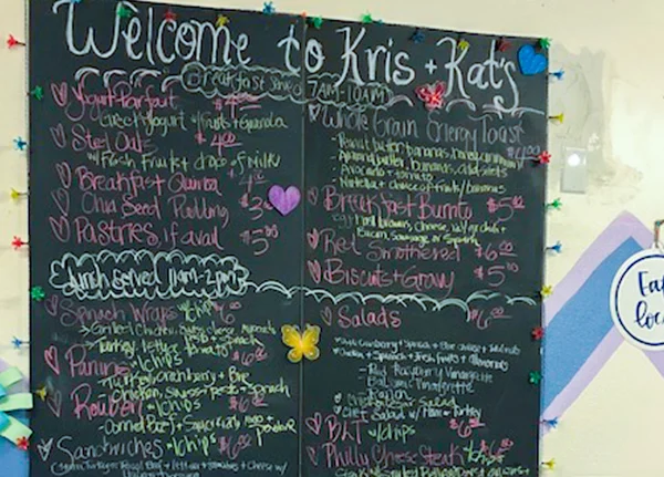 Sign that says Welcome to Kris and Kat's with a menu