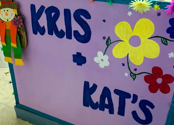Painted sign that says Kris and Kat's