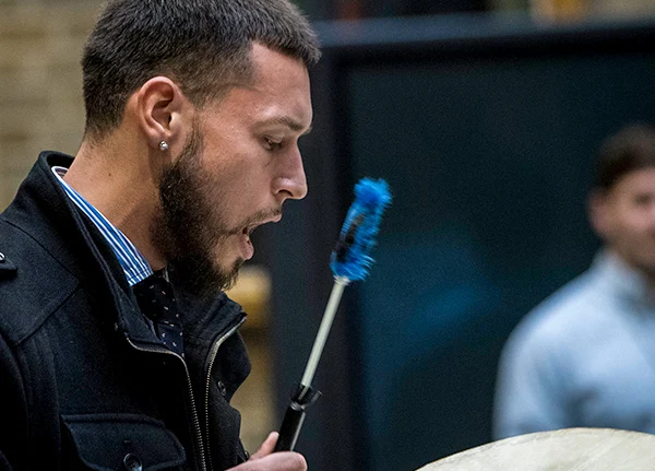 Man drumming and singing