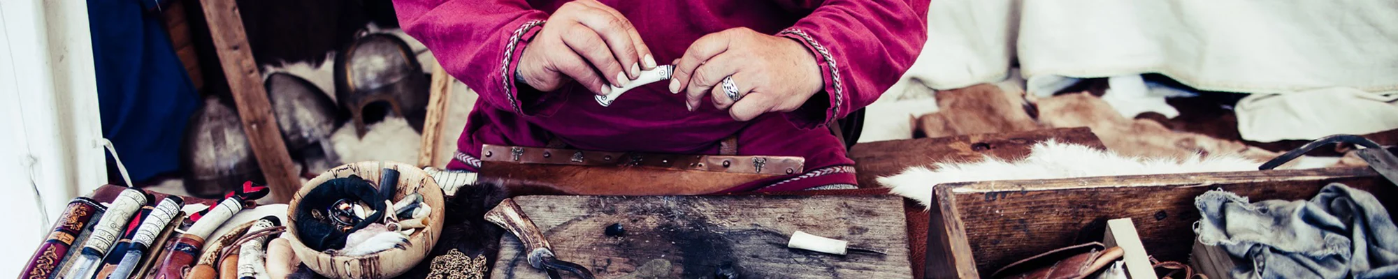 Hands making a knife handle out of bone
