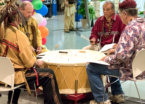Four drummers around a large drum