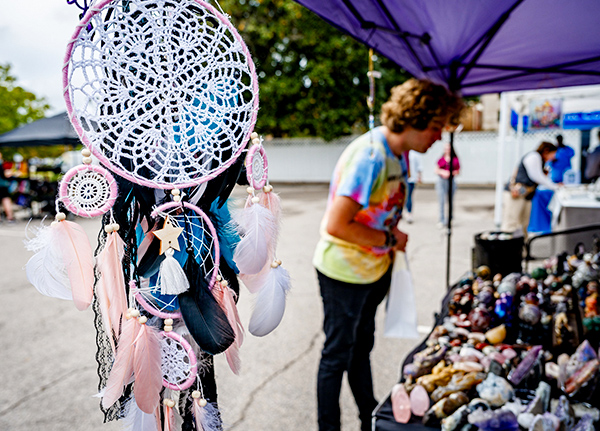 Dream catcher hanging from a vendor tent at an outdoor market