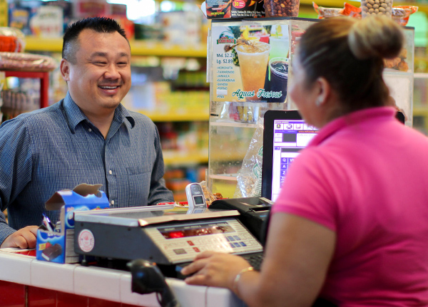 Man checking out at the register of a convenience store
