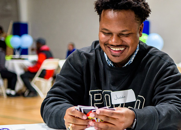 Man playing Uno and smiling