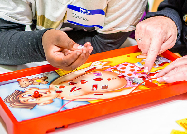 People playing the game Operation