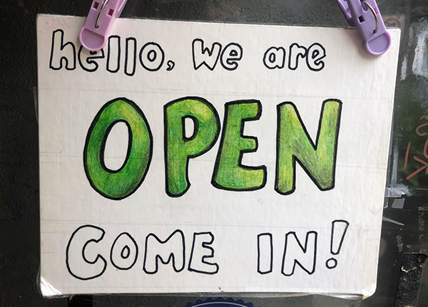 A sign that says Hello, we are open, come in!