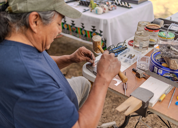 Artist pounding a small mallet