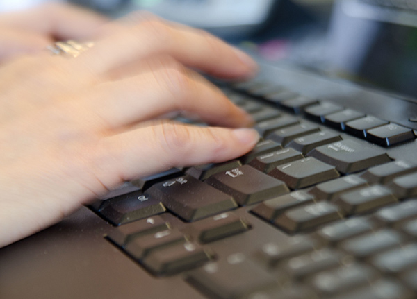 Hands tying on a keyboard