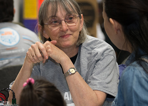 Woman sitting at a table listening to someone across from her