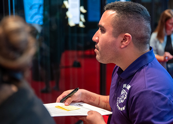 Man sitting at a table with paper in front of him