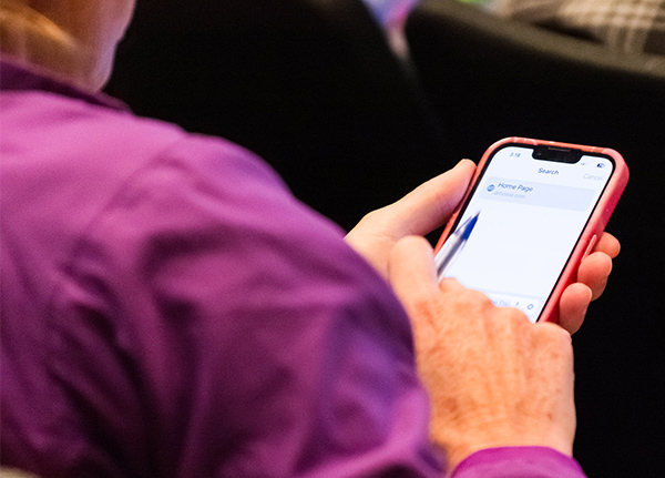 Person tapping on their phone screen