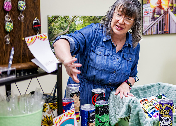 Woman selling bedazzled tumblers