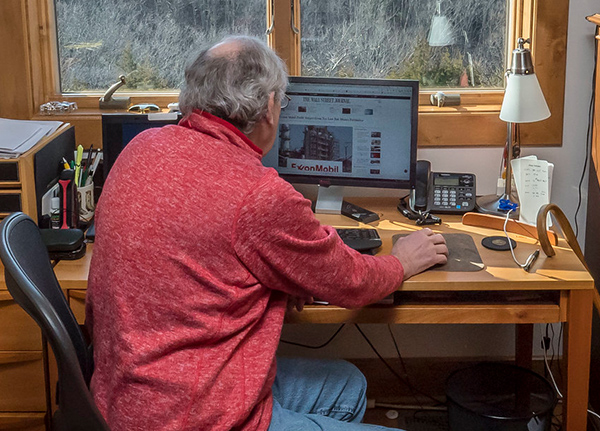 Older man sitting at a desk using a computer