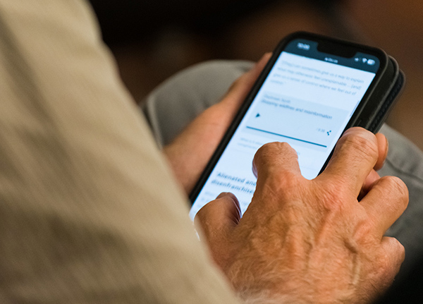 Hand tapping on a phone screen