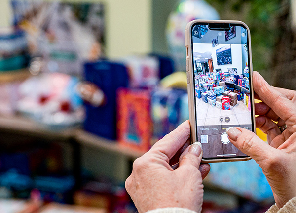 Person taking a phone of products with their phone