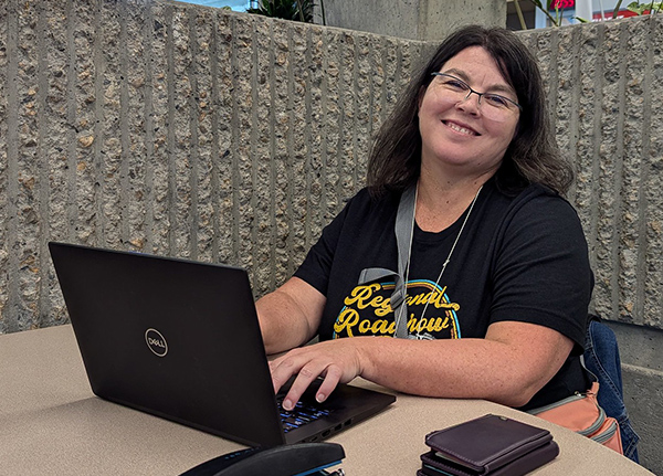 Woman sitting and typing on a computer