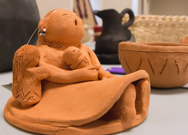 Clay figurine of a woman holding children