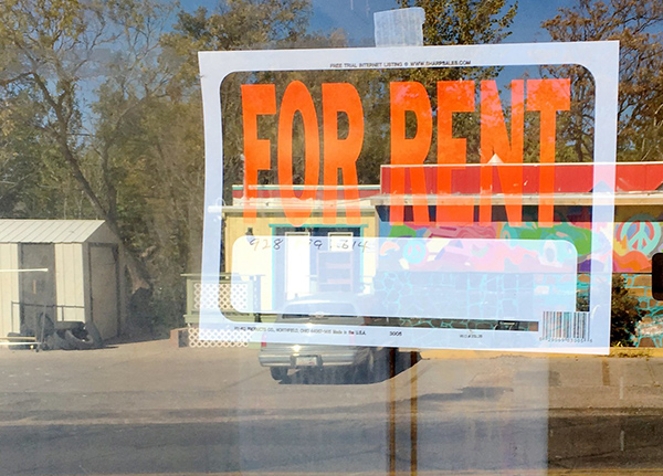 A For Rent sign in a window