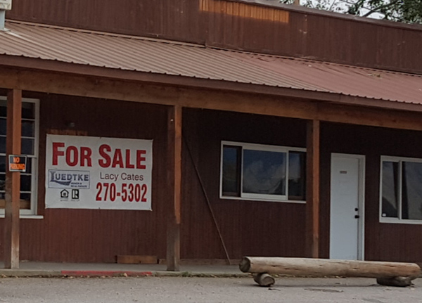 Building with For Sale sign on it