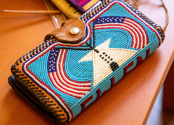 A beaded wallet with a tribal design