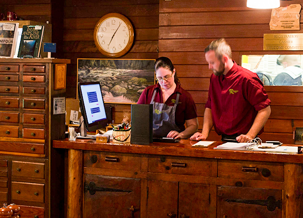 Restaurant with two workers behind the checkout counter
