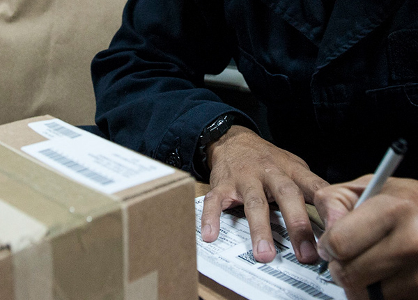 Person filling out mailing information for a package