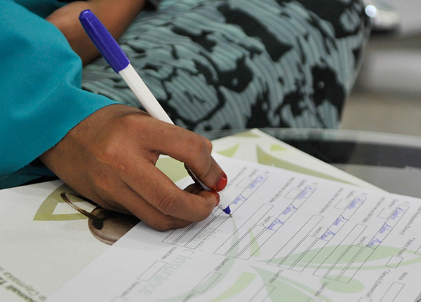 Hand filling out a form