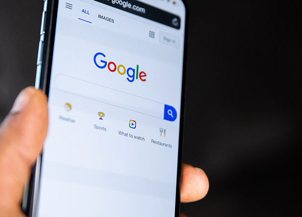 Hand holding a phone with Google pulled up