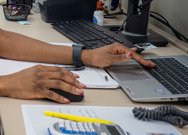 Hands typing on a laptop