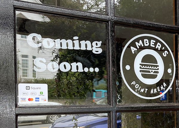 Window with a Coming Soon decal on it