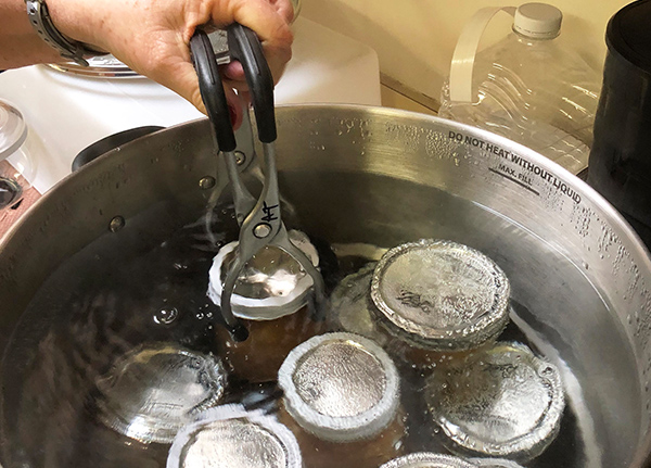 Person canning jars under water