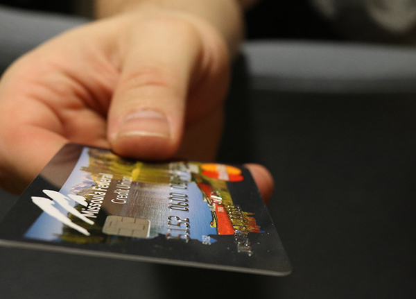 Hand holding a debit card