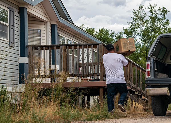 Man carrying a box into a home
