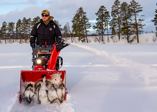 Man pushing a snow blower